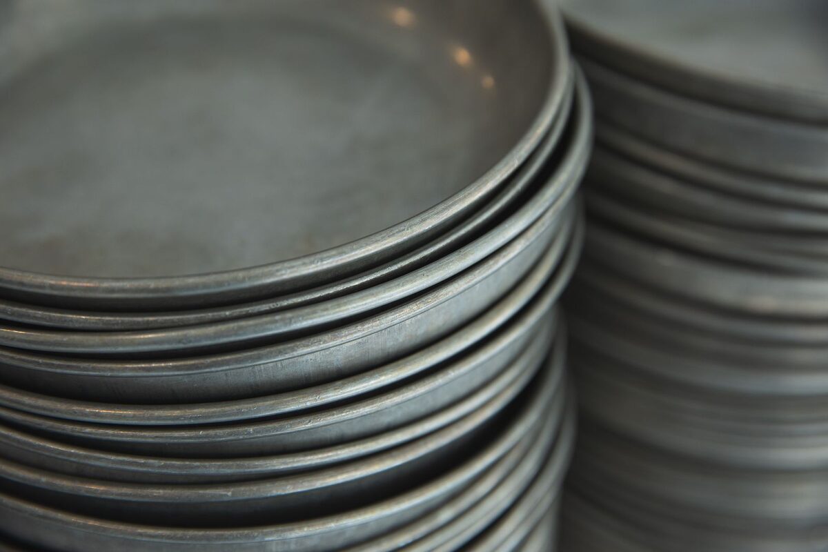 Stock photo: steel thali plates stacked and ready for a tiffin order